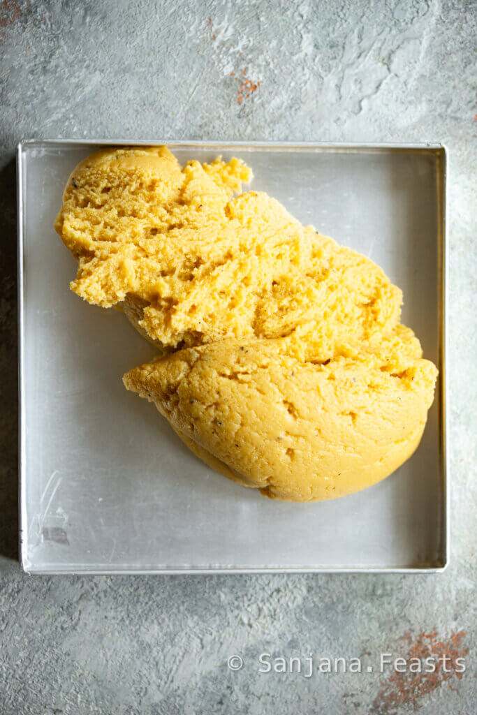 Press the barfi mixture into a tin