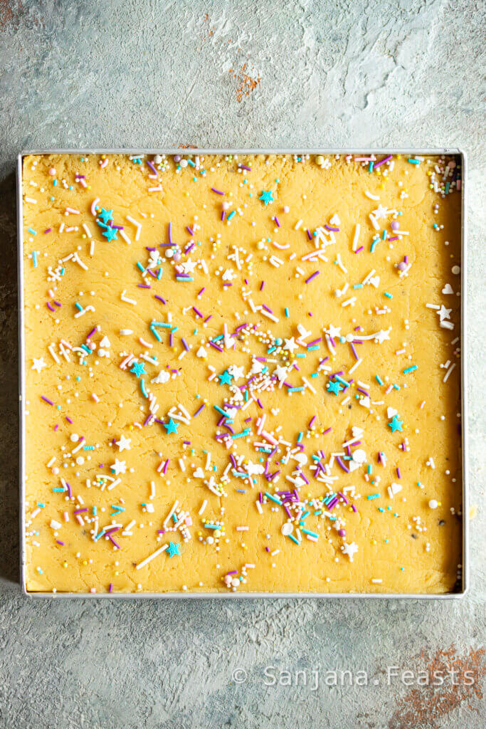 Decorate barfi with sprinkles