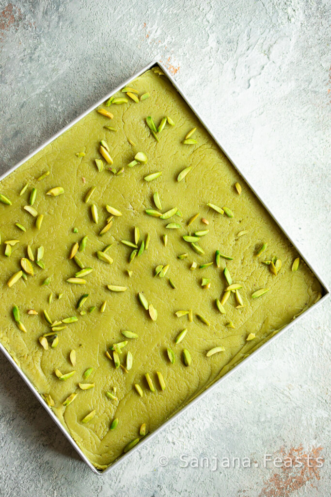 pistachio barfi setting in a tray