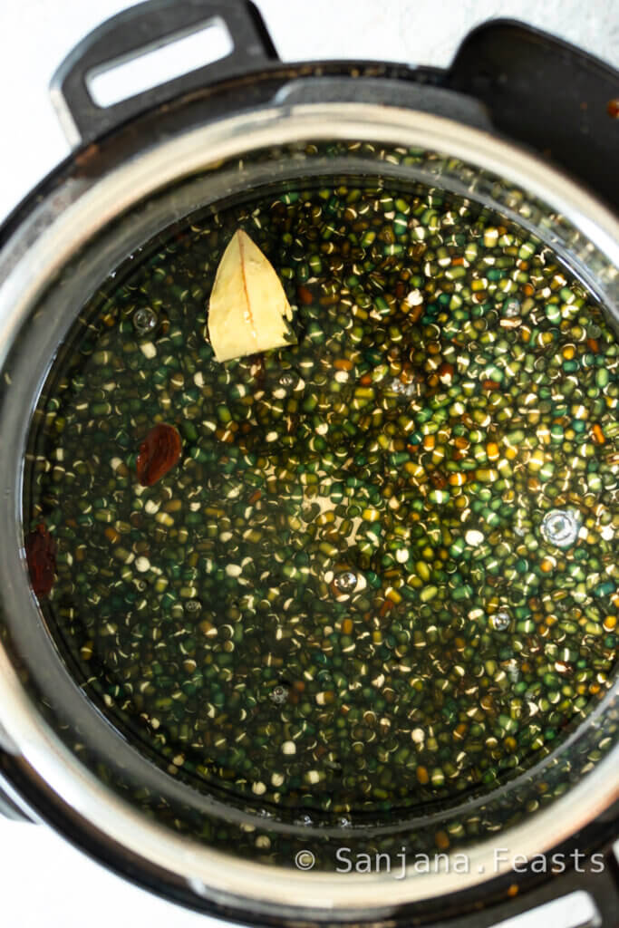 Add spices to cooking water with black dal