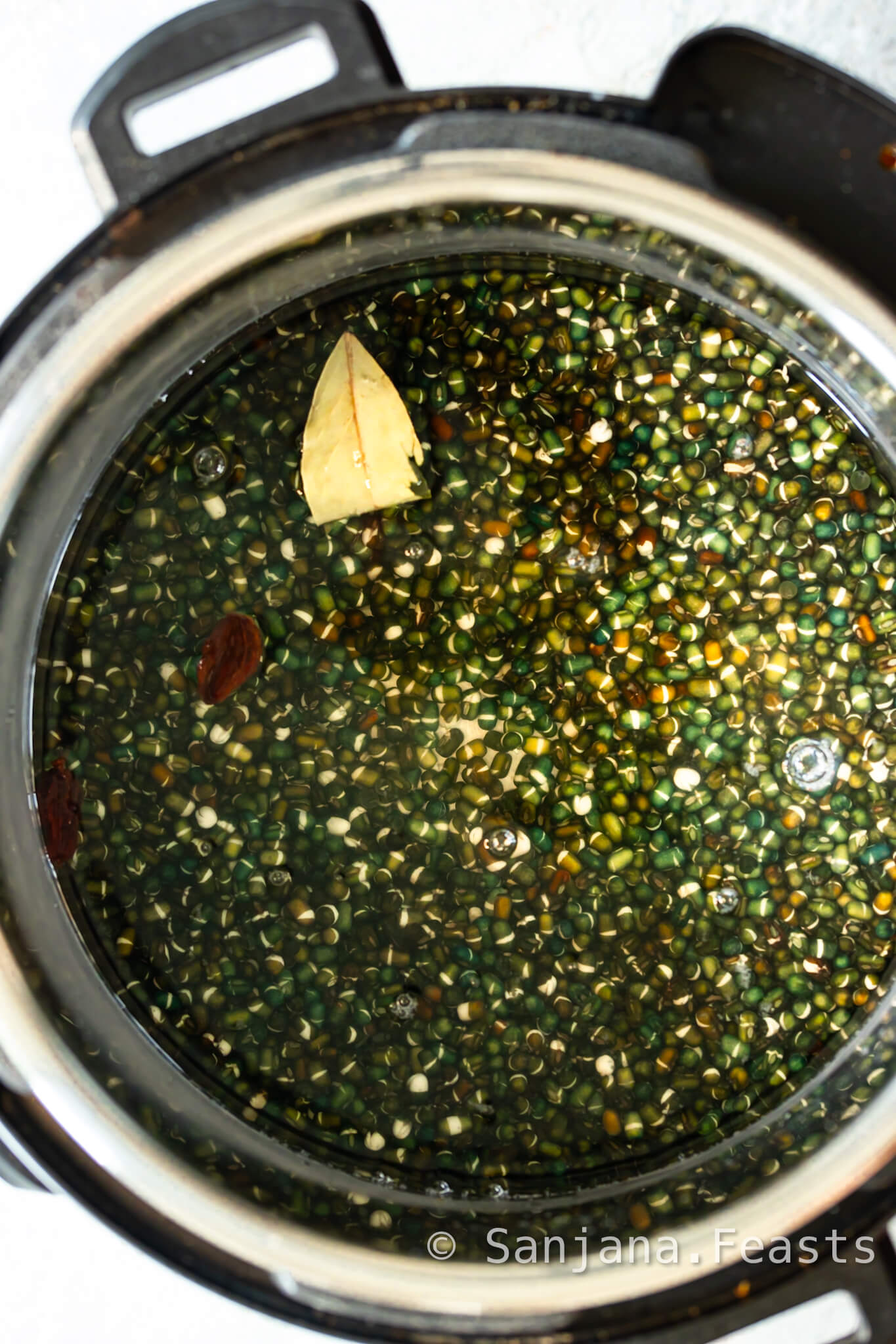 Add spices to cooking water with black dal