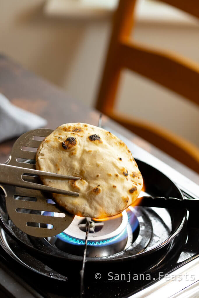 finish cooking the naan over open flame