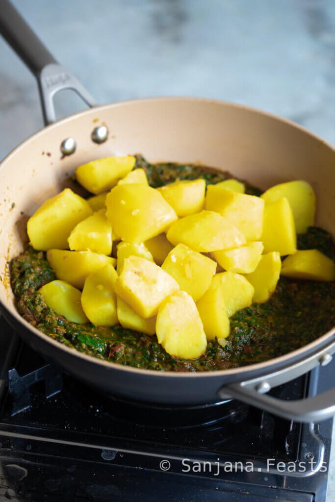 Add potatoes to the spinach mixture