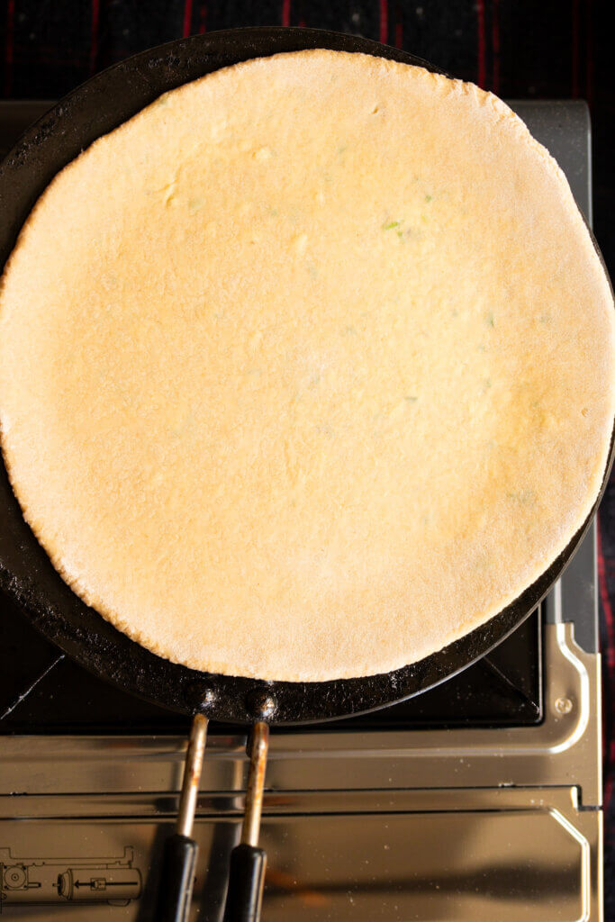 cook first side of paratha on tawa